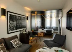 a hotel room with a black and white picture on the wall