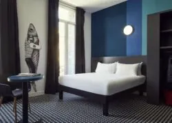 a hotel room with a bed and a fish on the wall