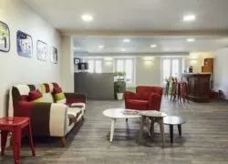 a living room with a colorful couch and chairs