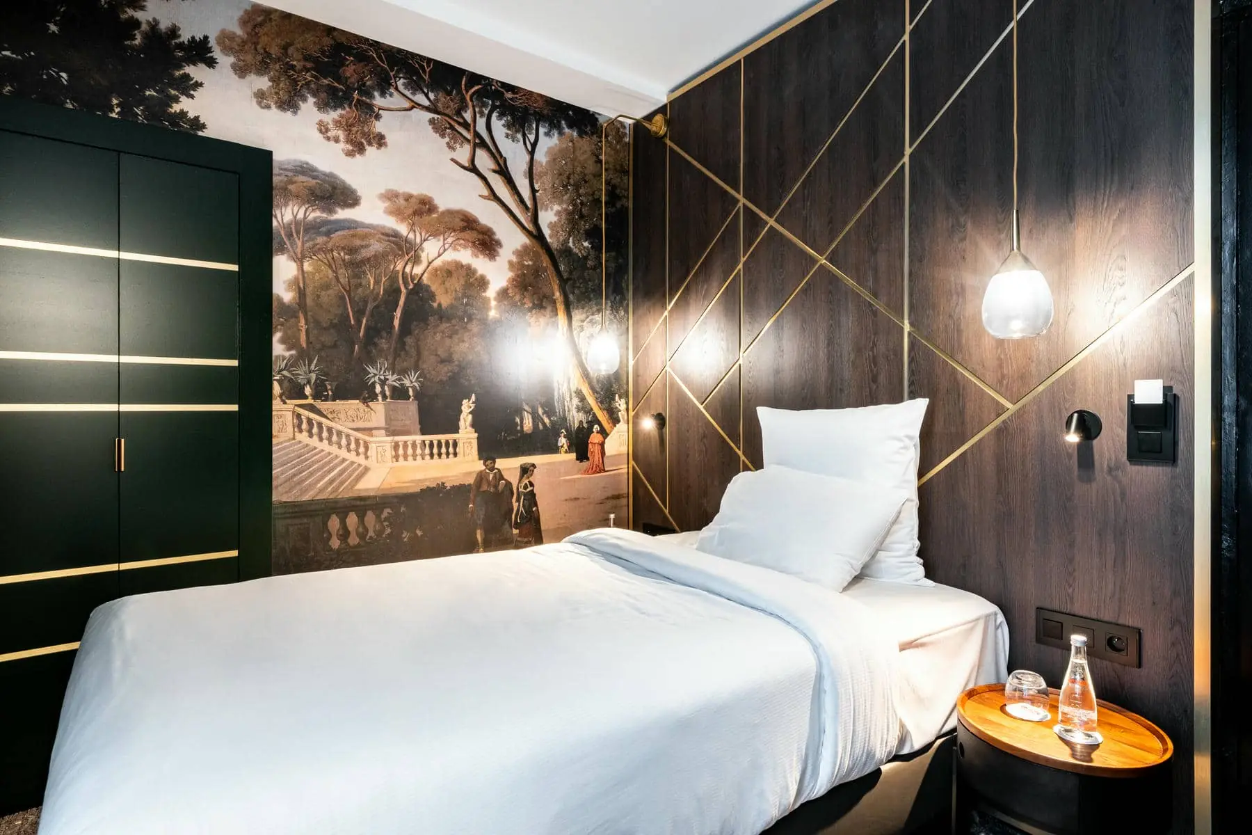 a bed in a hotel room with a painting on the wall