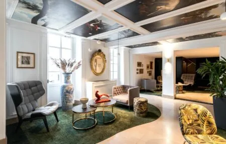a living room with a painting on the ceiling