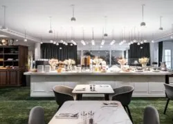 a dining room with tables and chairs and a buffet