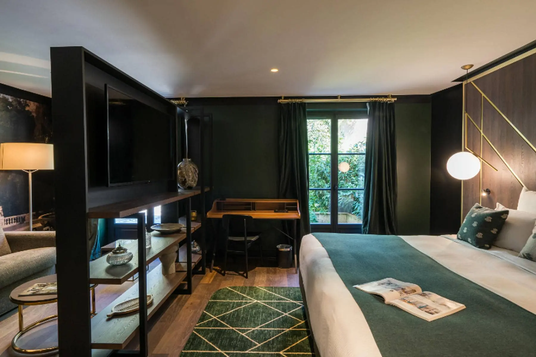 a bedroom with a large bed and a desk
