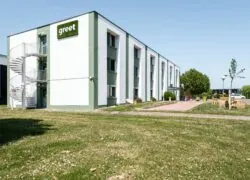 a green and white building with the word greet on it