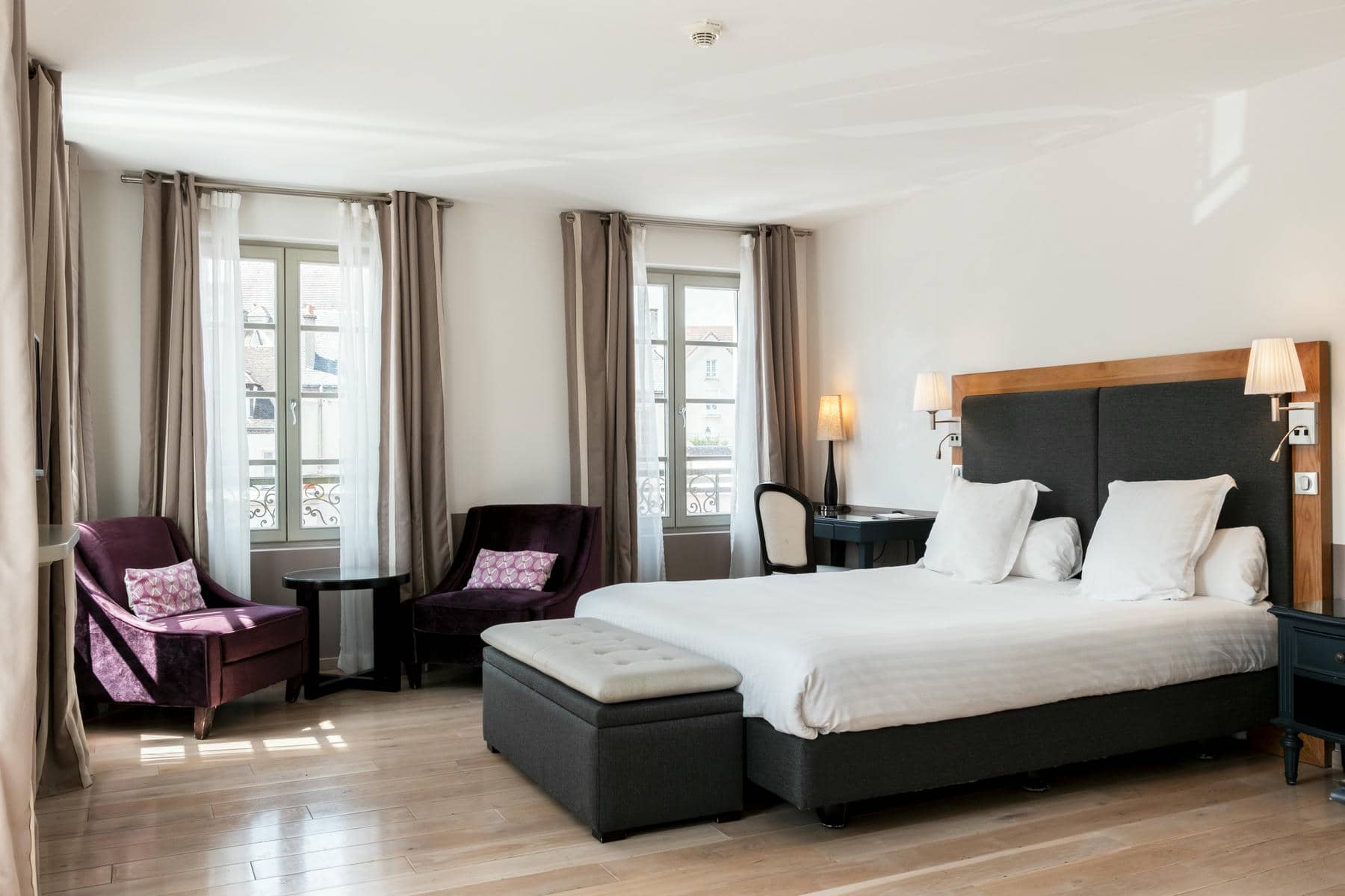 une chambre d'hôtel avec un grand lit et deux chaises
