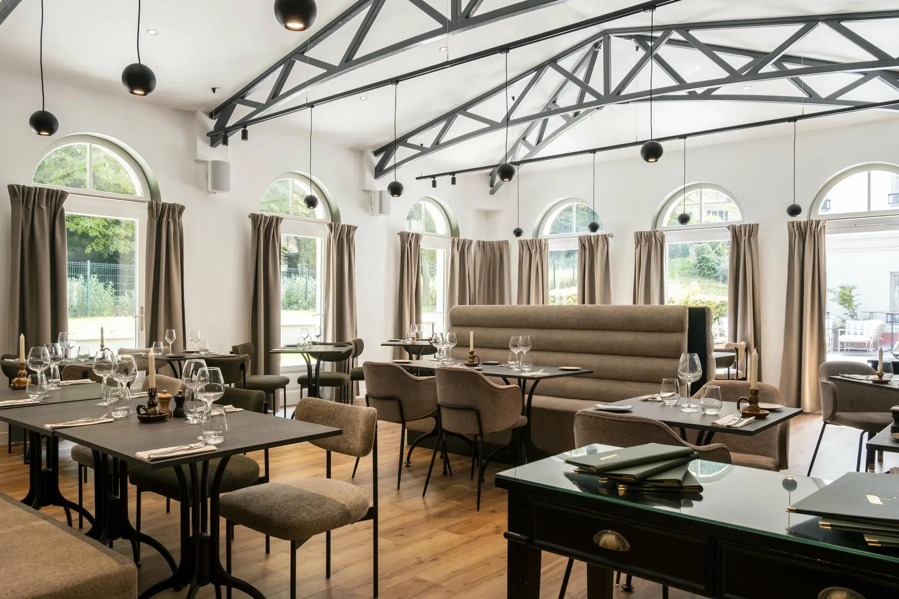 une salle à manger avec tables et chaises et une grande fenêtre