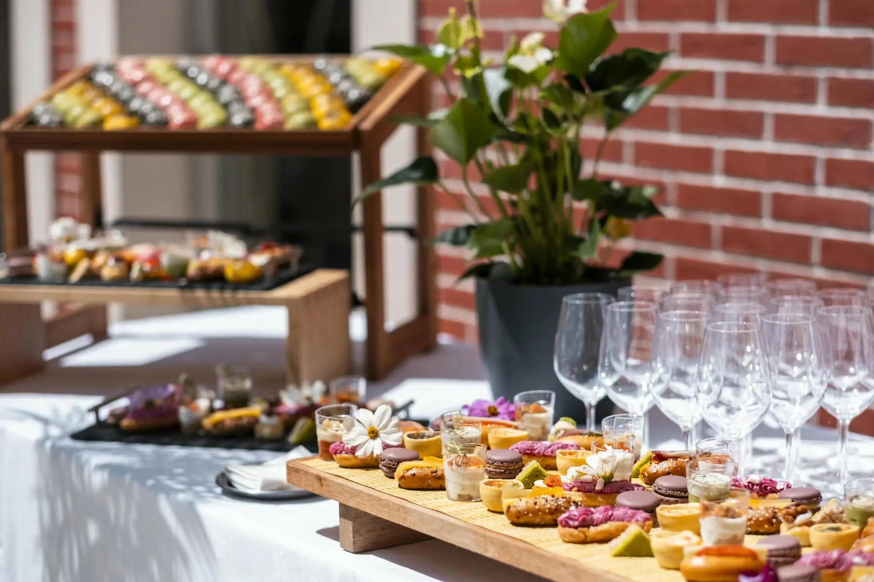 un étalage de nourriture et de verres à vin devant un mur de briques
