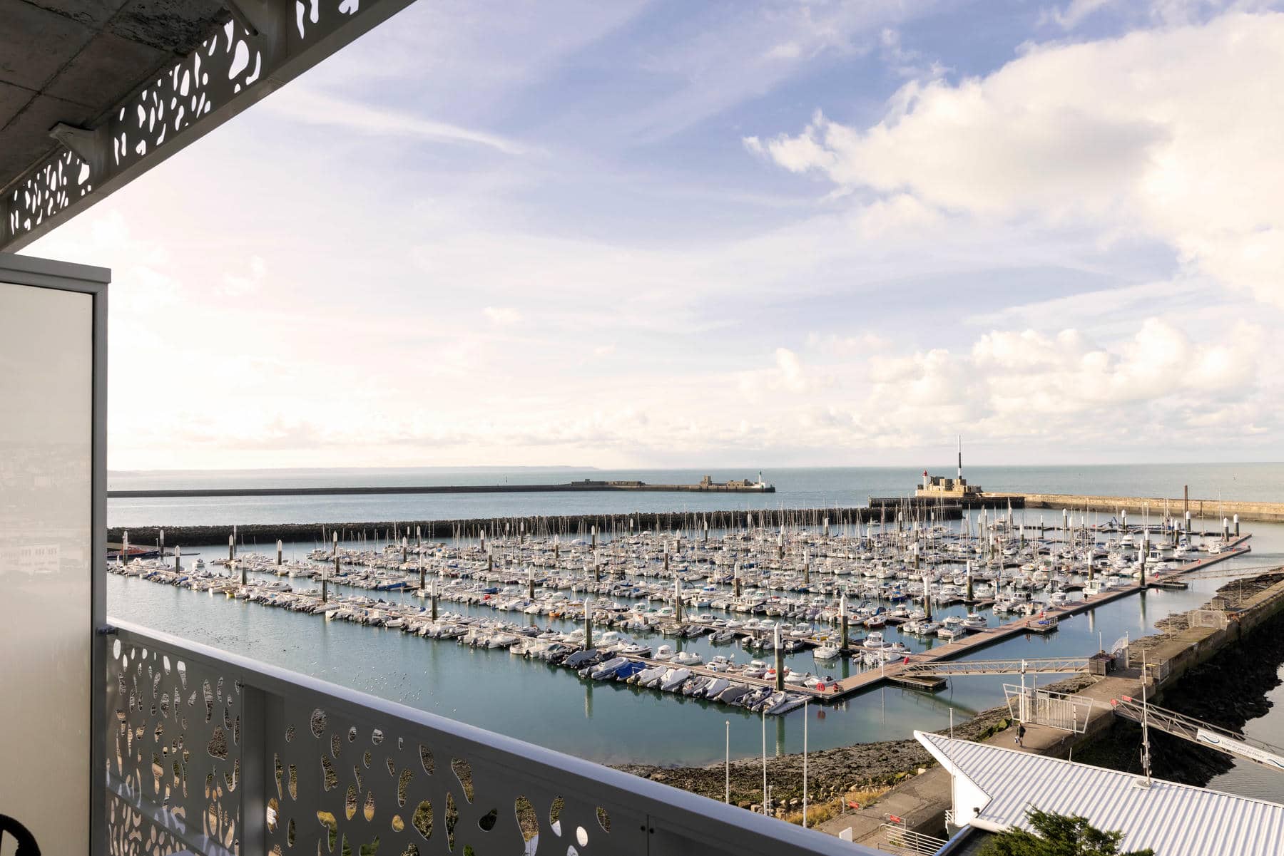 a view of a marina from a balcony with a white railing