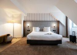 a hotel room with a bed and a book on it