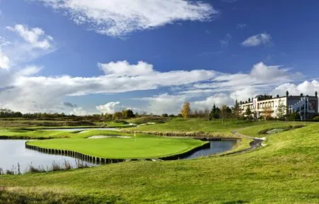 a golf course with a large building in the background
