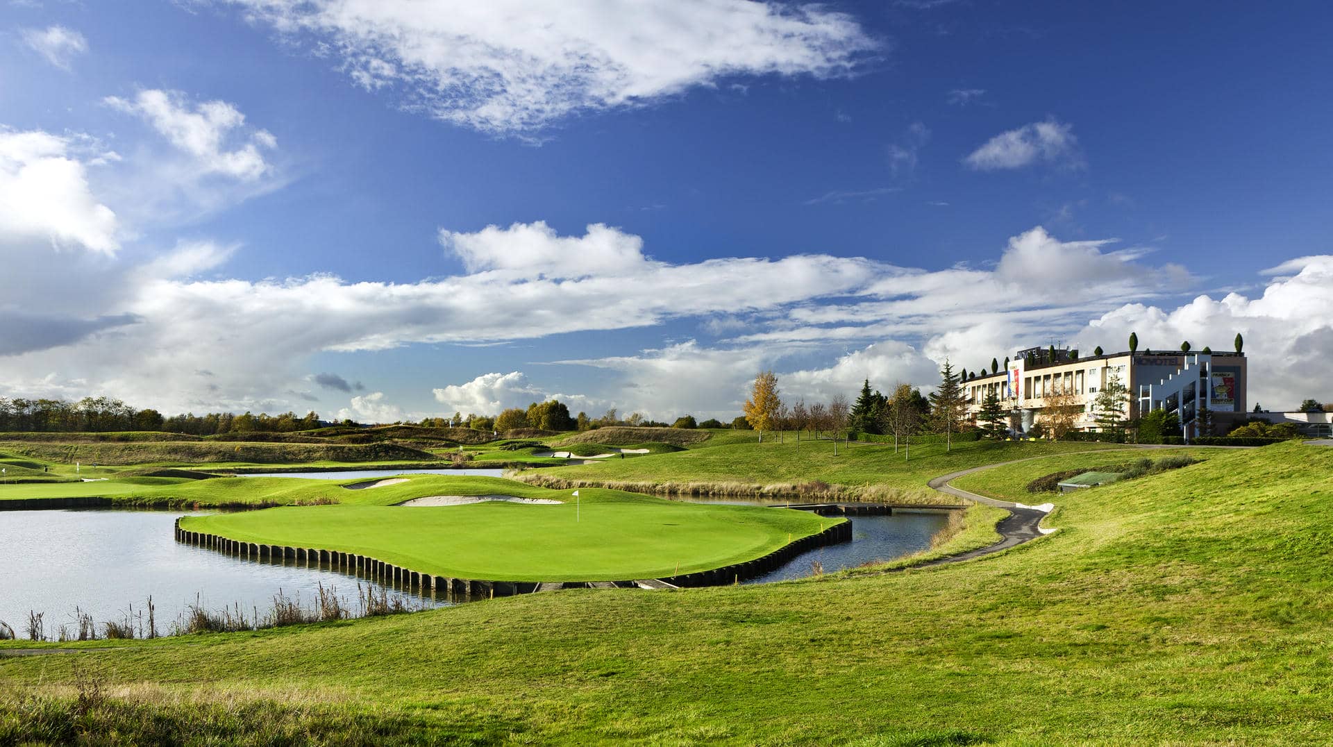 a golf course with a large building in the background