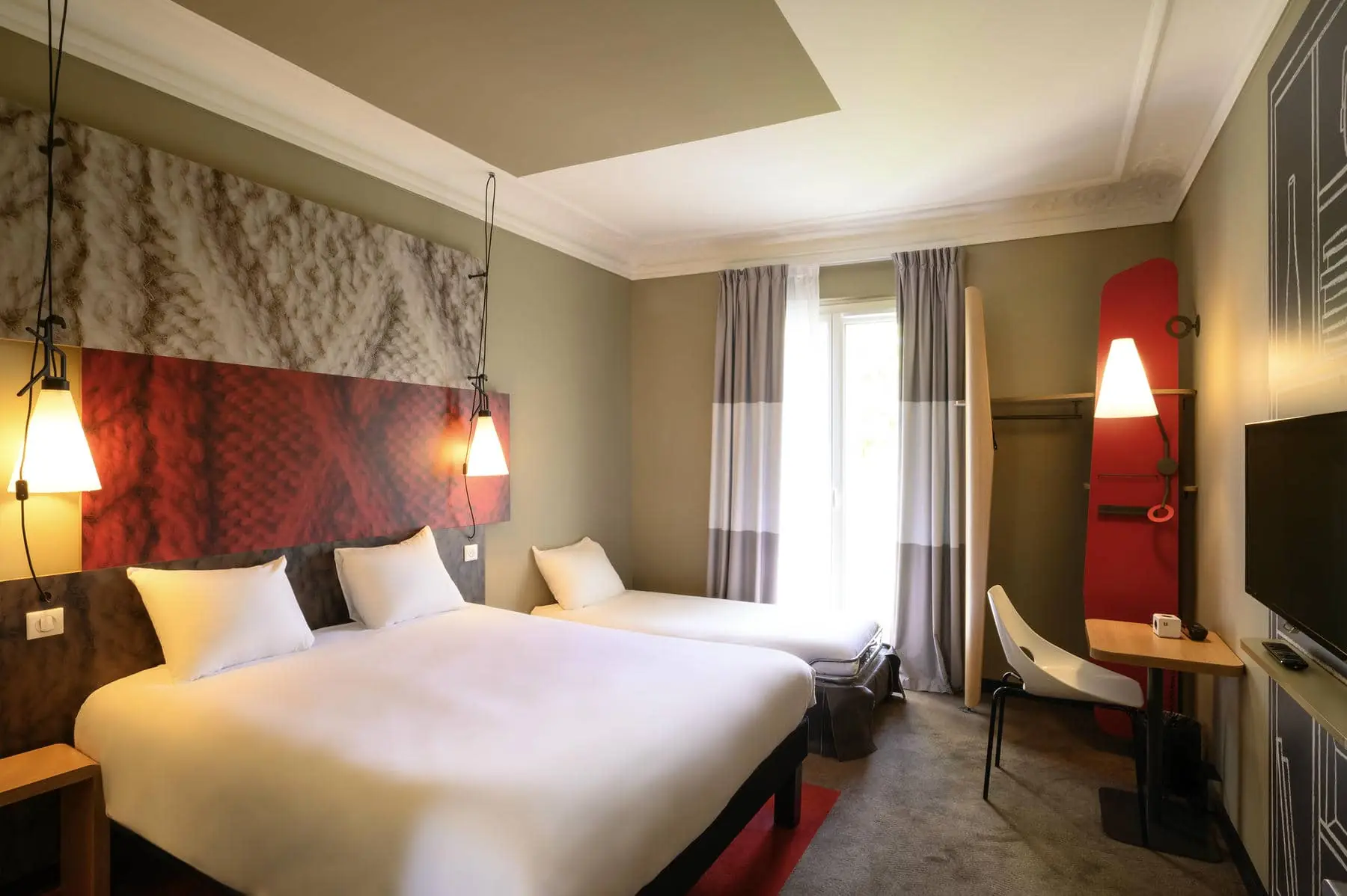 a hotel room with two beds and a table