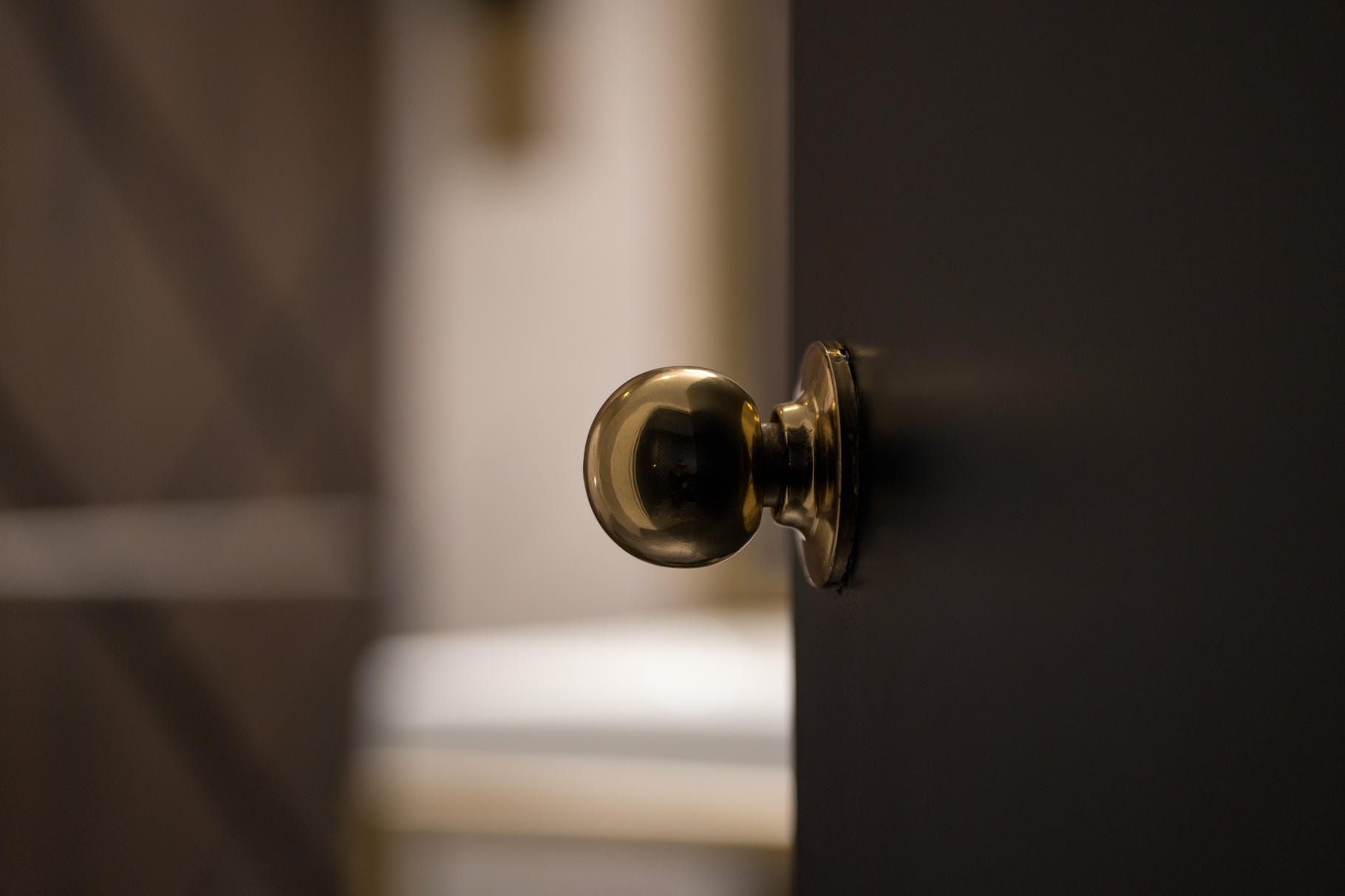 a close up of a door knob on a black door
