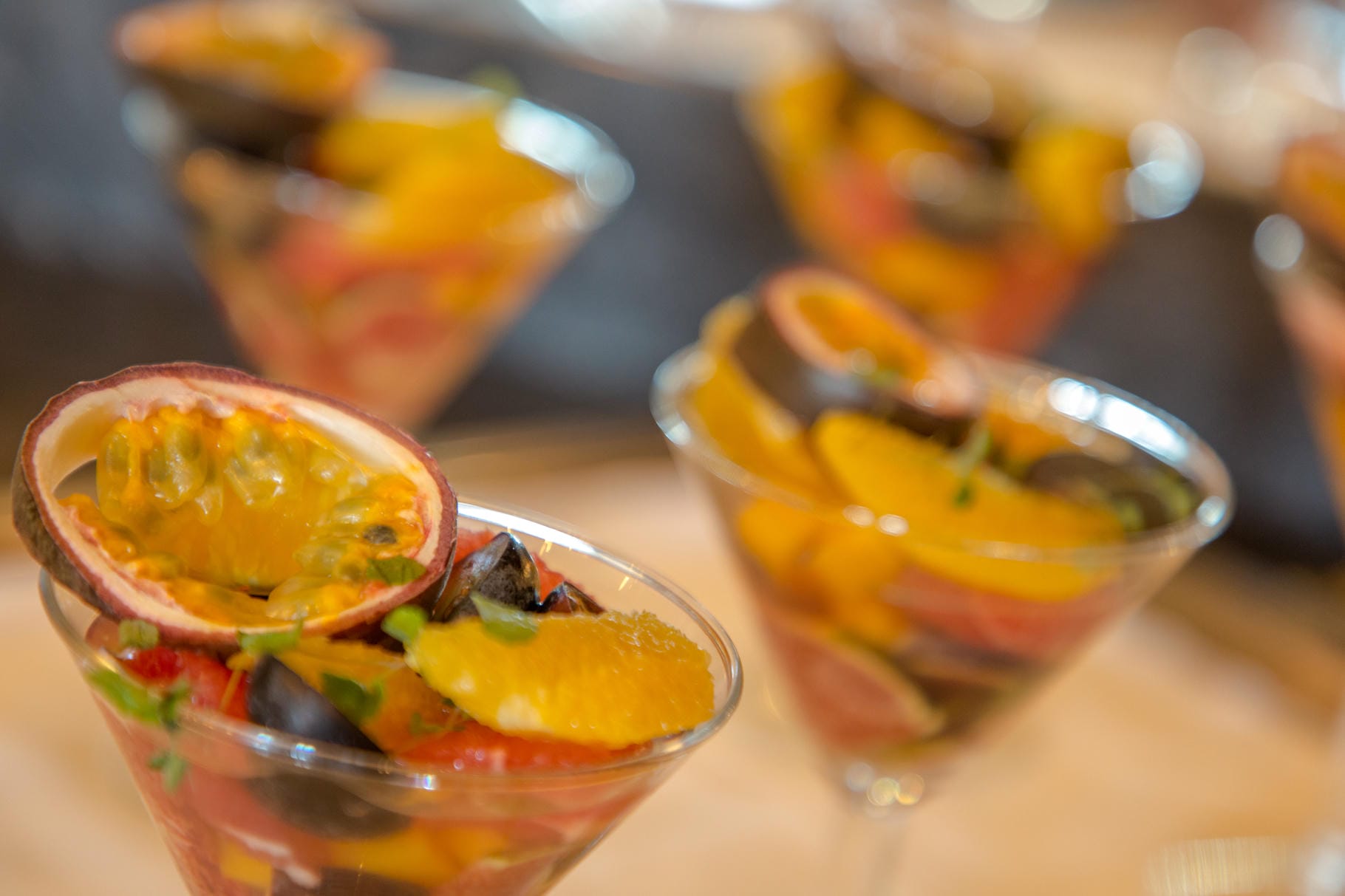 a close up of a martini glass filled with fruit