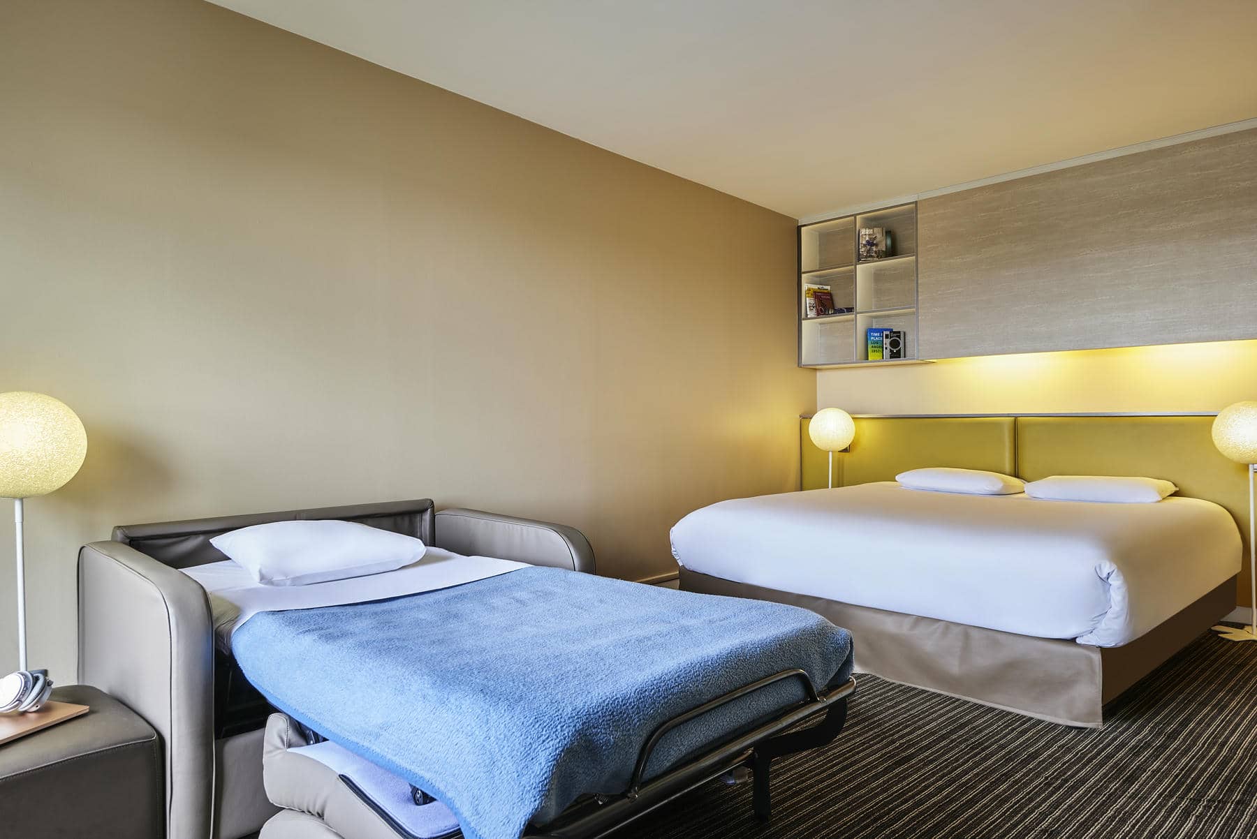 a hotel room with a bed and a couch