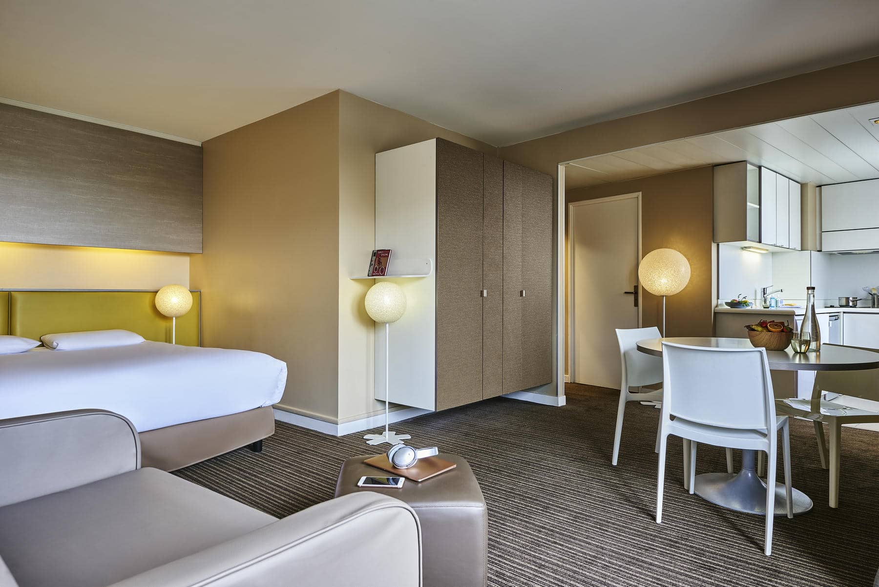 a hotel room with a table and chairs and a bed