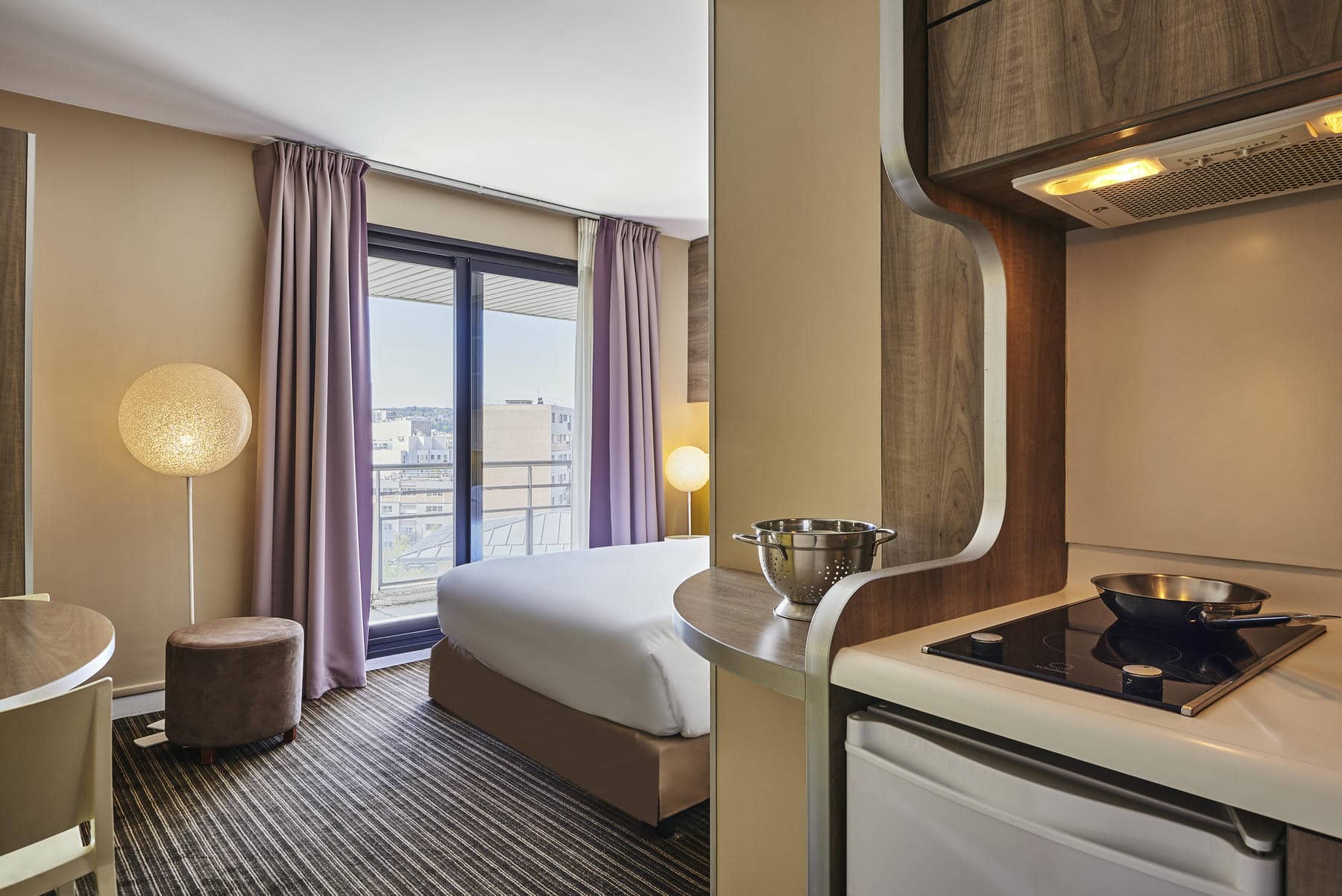 a hotel room with a sliding glass door leading to a balcony