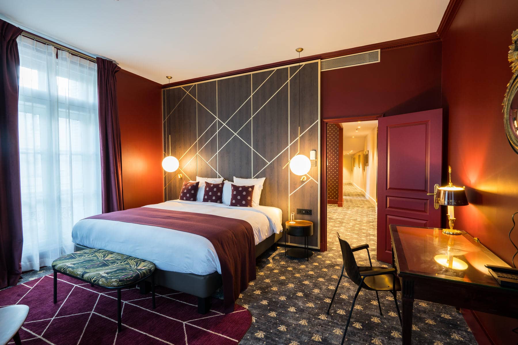 a hotel room with a large bed and a desk