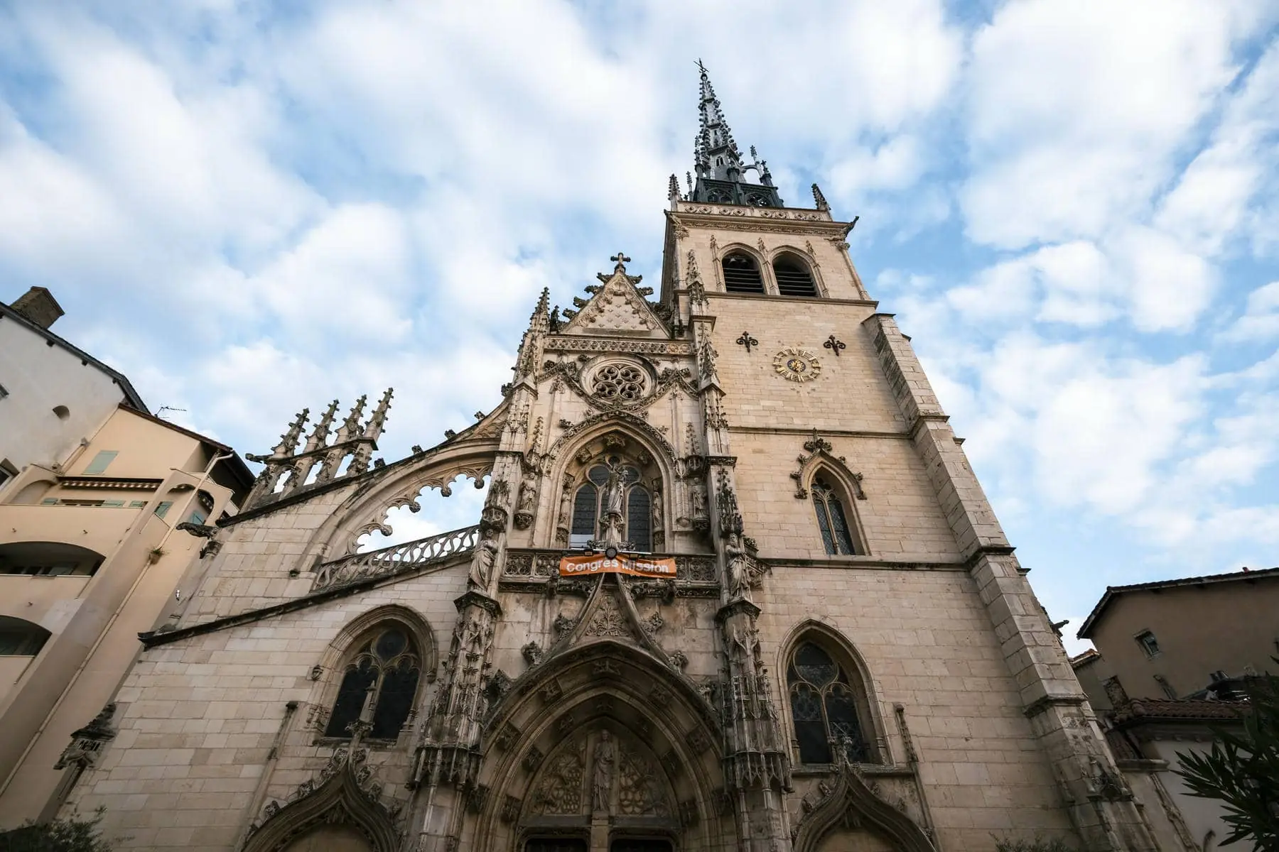 a large church with a banner hanging from the tower that says " l' amour "