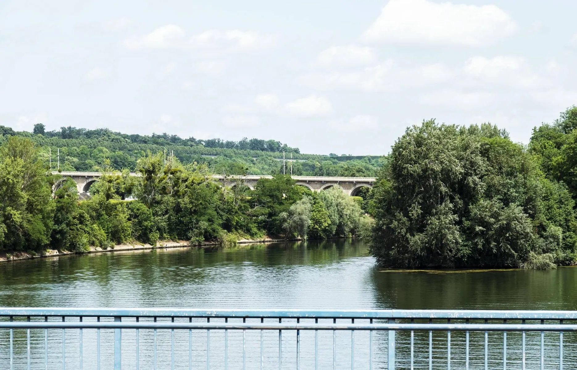 a bridge over a river with a bridge in the background