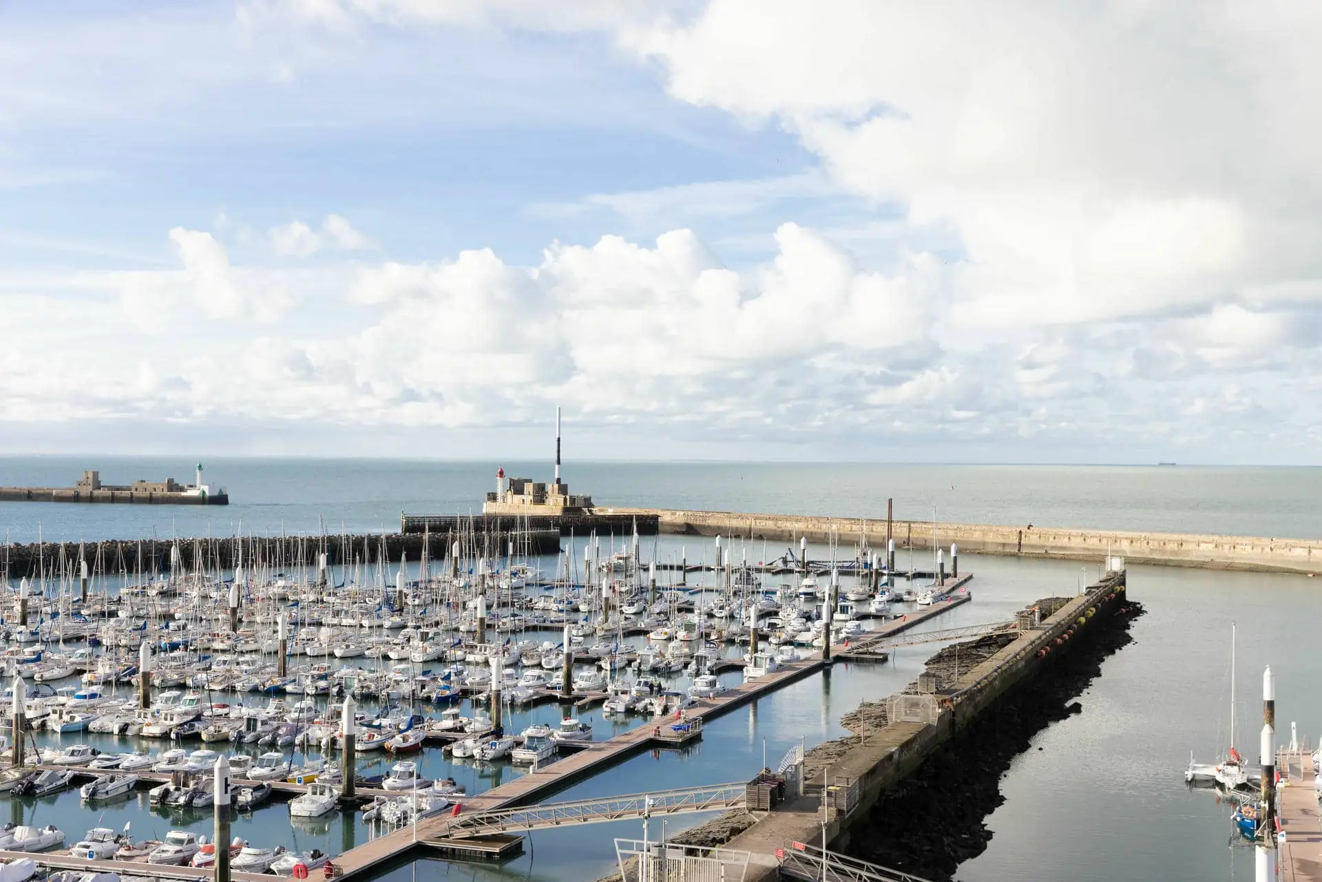 boats are docked in a marina with a castle in the background