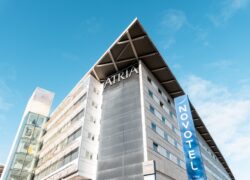 view of the upper part of the Novotel Belfort Centre Atria hotel façade, rising toward the sky