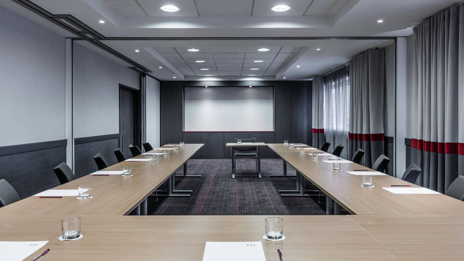 a conference room with tables and chairs set up for a meeting