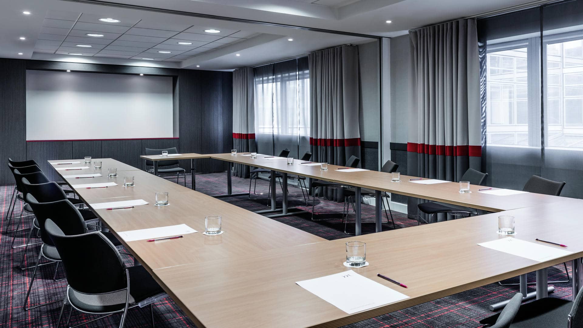 a conference room with tables and chairs set up for a meeting