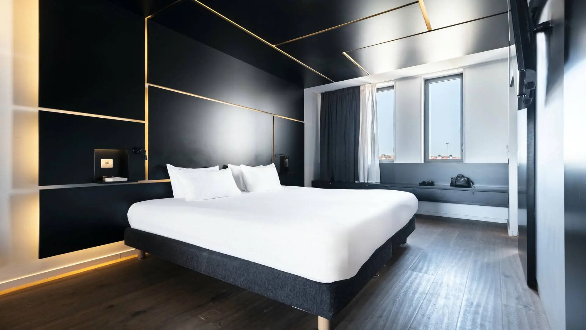 a hotel room with a bed and a desk
